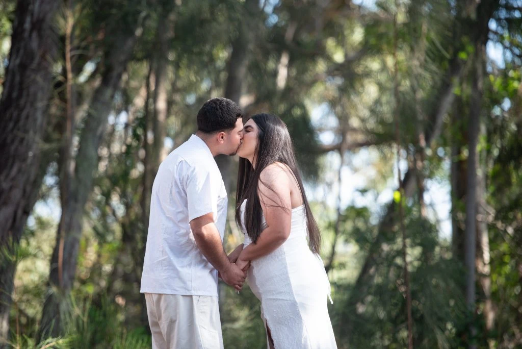 Couple kissing during outdoor ceremony