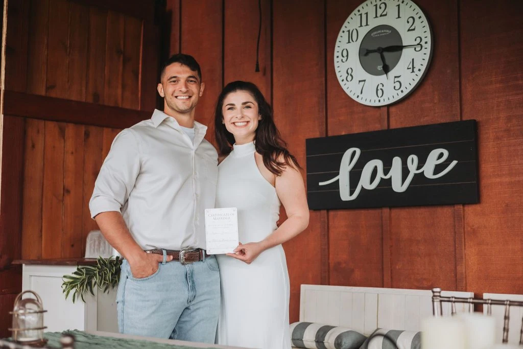 Newlyweds celebrating with a marriage certificate