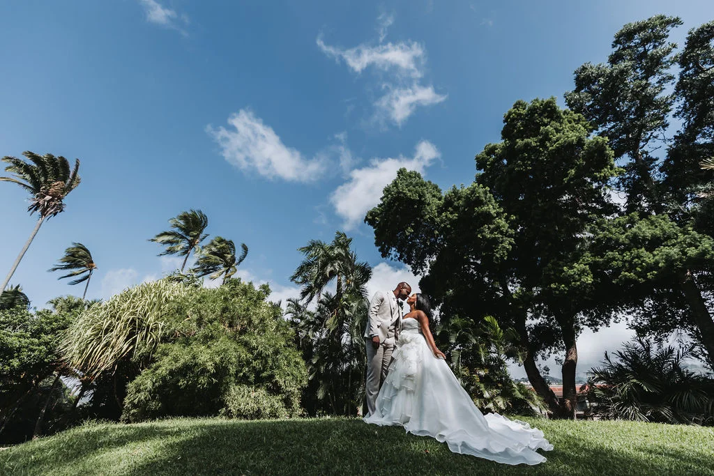 Bride and groom kissing in a garden