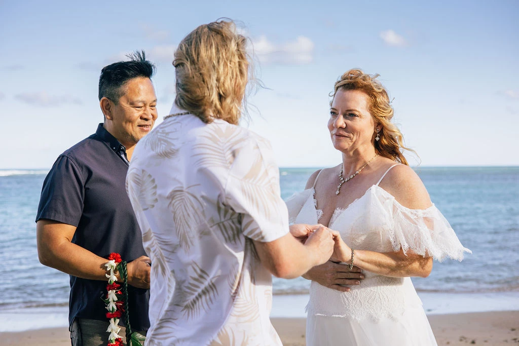 Couple exchanging vows by the ocean