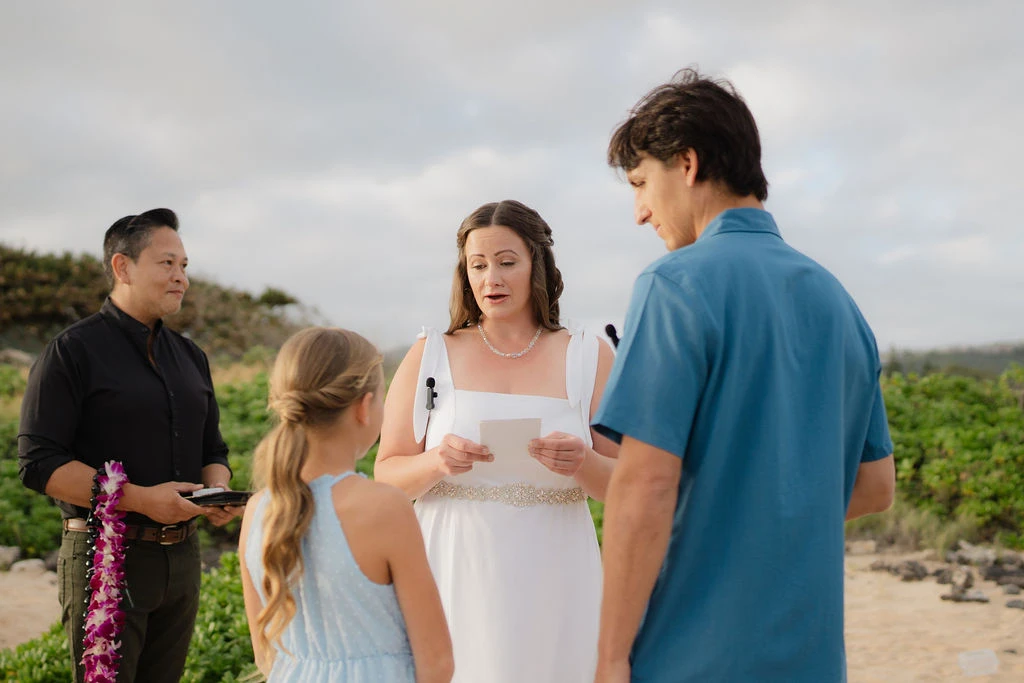 Bride reading vows on beach