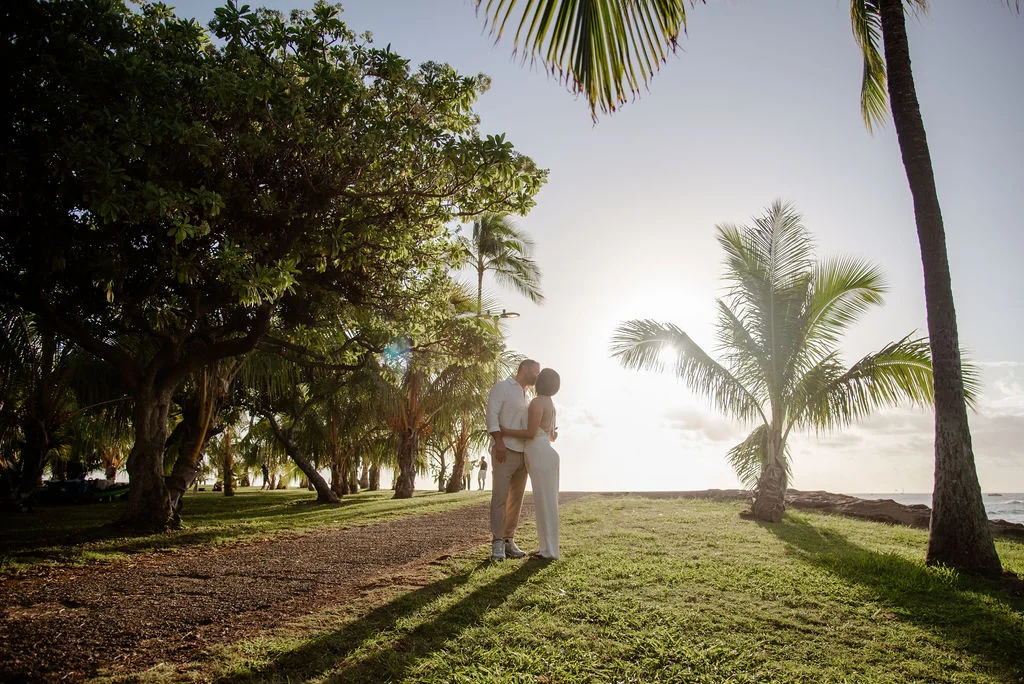 Couple kissing under palm trees