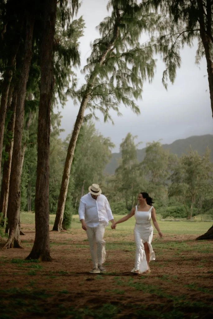 Couple walking hand in hand in the woods