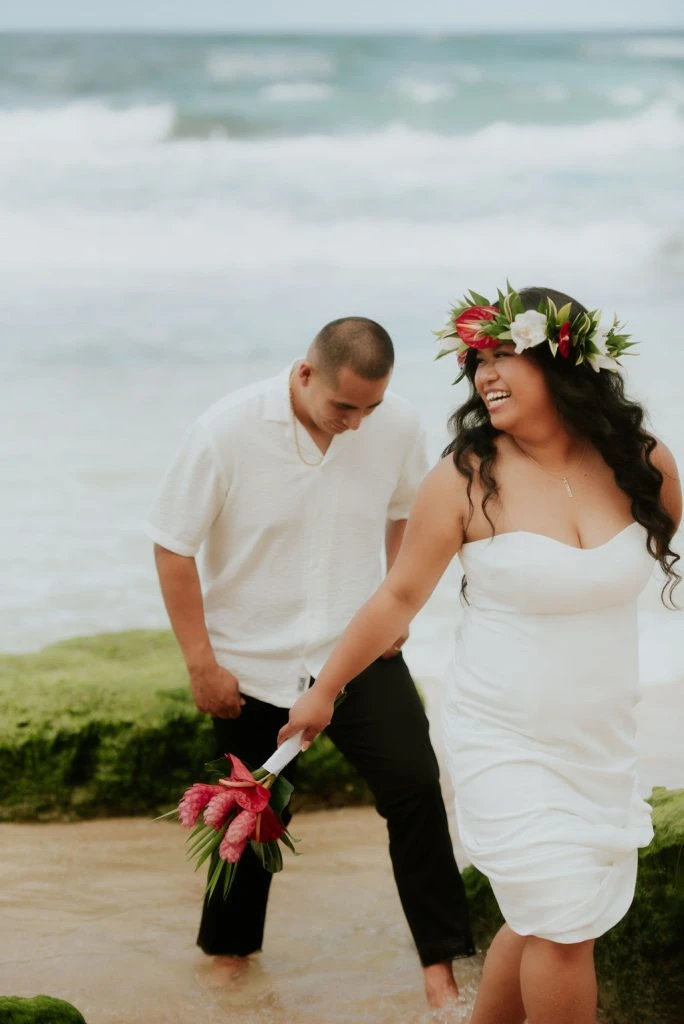 Joyful couple walking by the shore