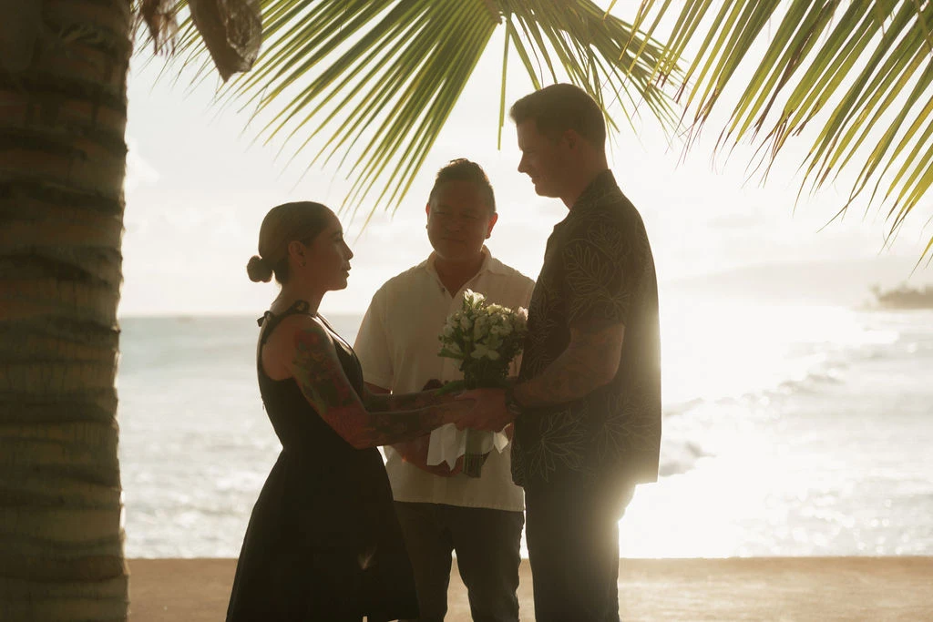 Couple exchanging vows by the ocean.