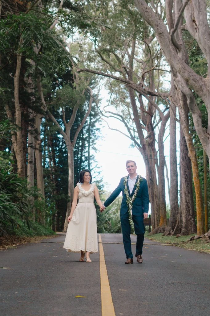 Couple walking hand in hand on a forest road