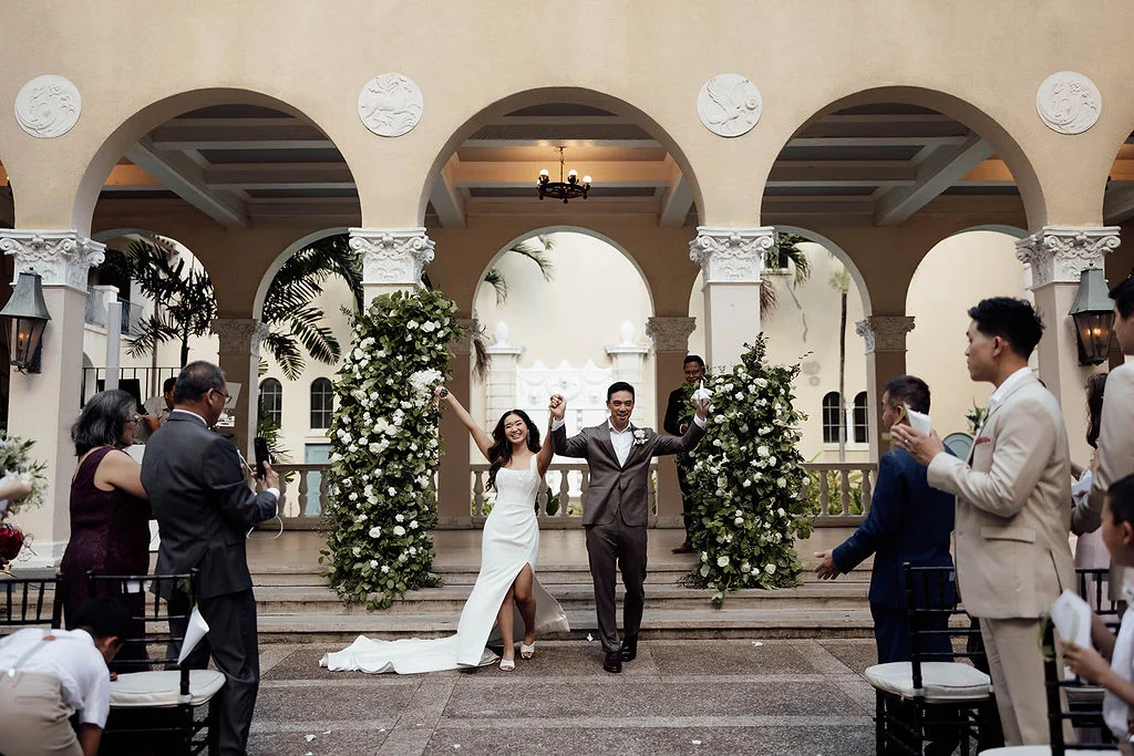 Newlyweds celebrating down the aisle