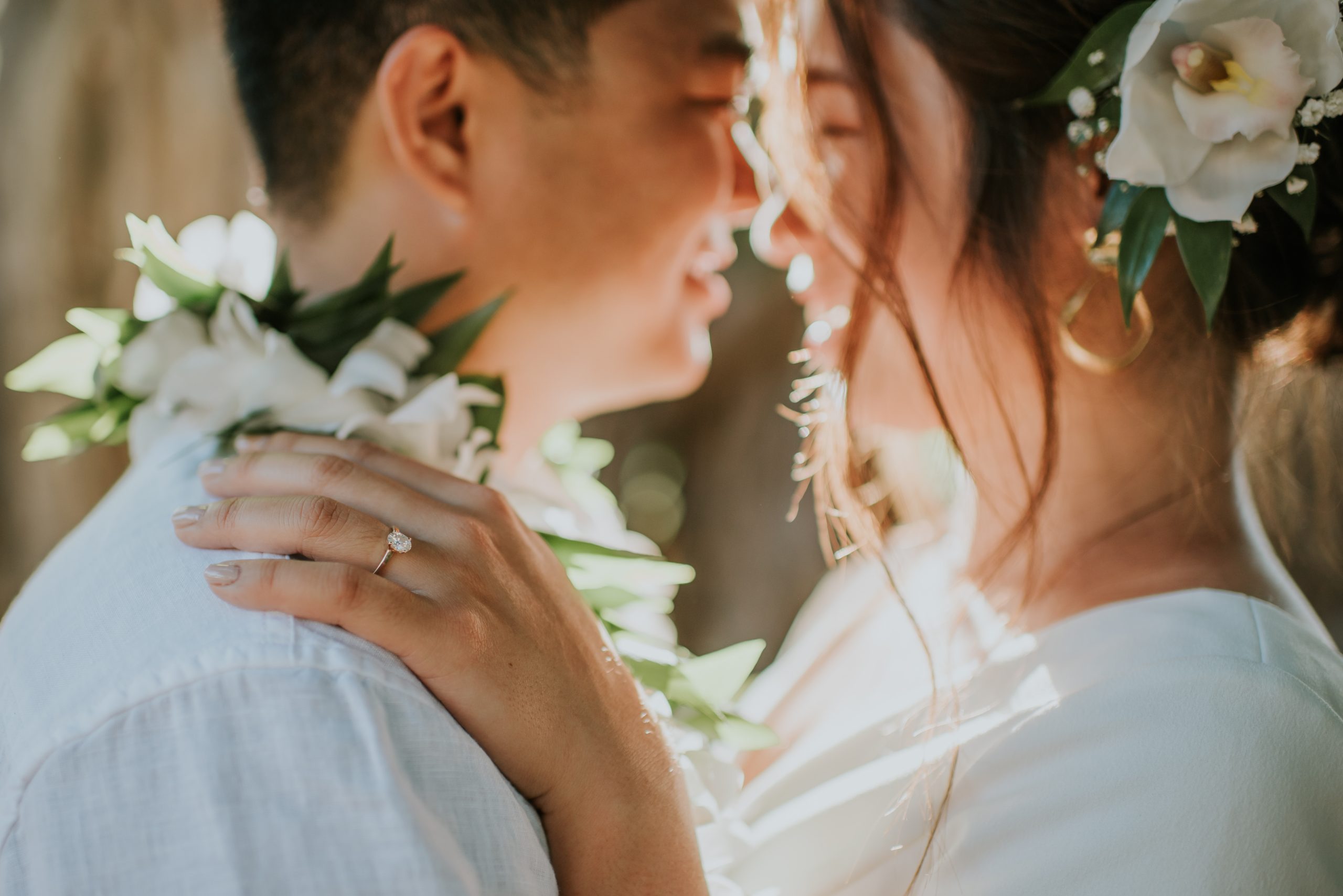 Intimate beach ceremony exchanging leis during an Oahu elopement