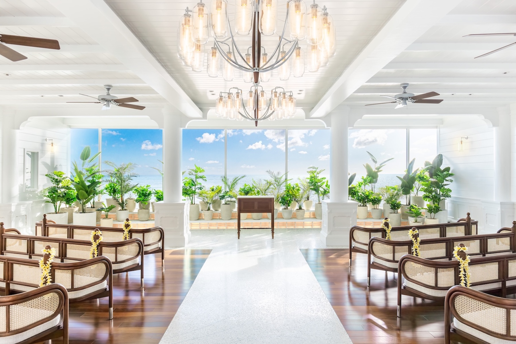 Step inside the serene oceanfront sanctuary of Kahawai Chapel at the Outrigger Reef Waikiki Beach Resort, where soaring floor-to-ceiling glass seamlessly blends your vows with an infinite, sparkling blue Pacific horizon.