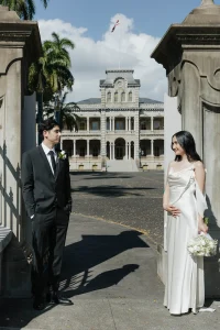 Couple navigating Hawaii marriage and immigration licensing outside historic Iolani Palace in downtown Honolulu Oahu