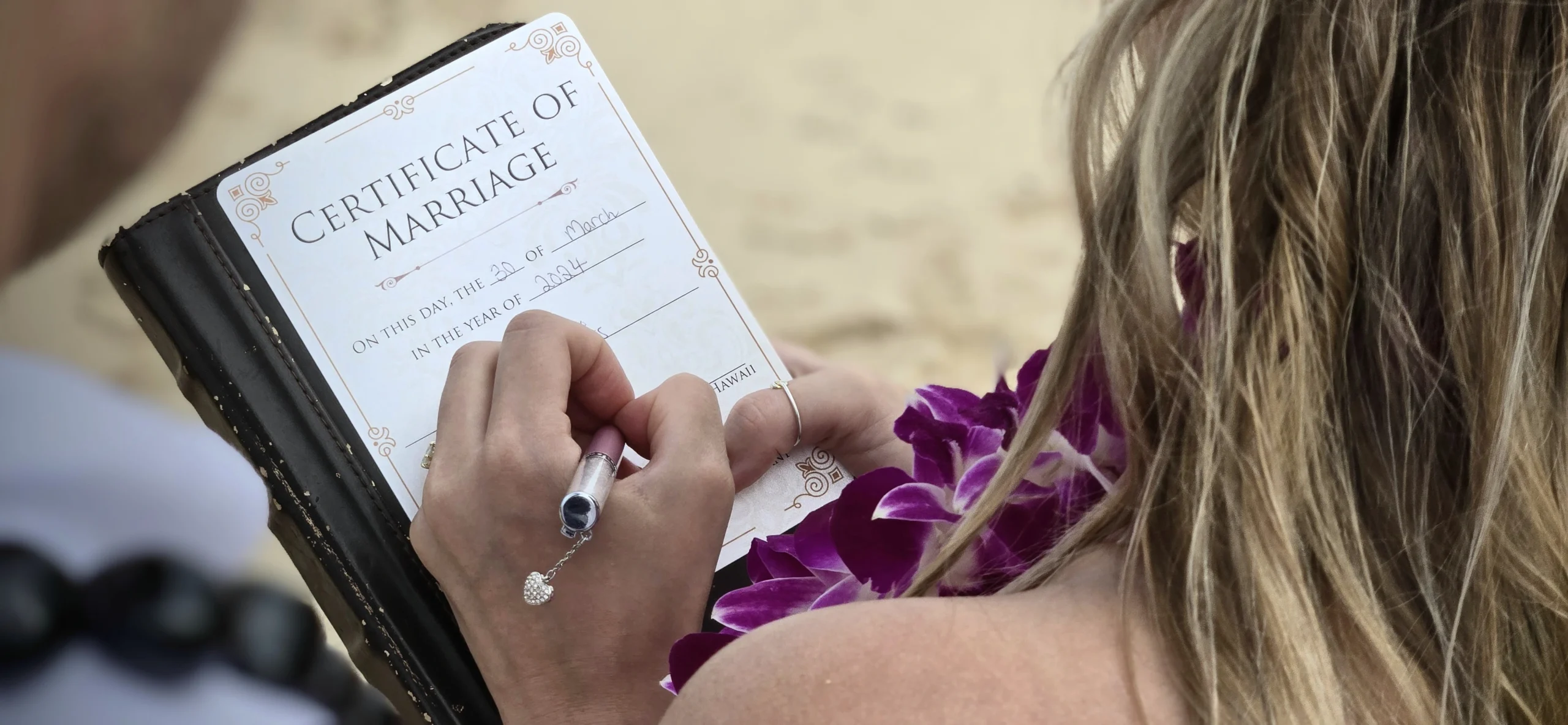Bride signing marriage license worksheet for Hawaii marriage and immigration legal recording on Oahu